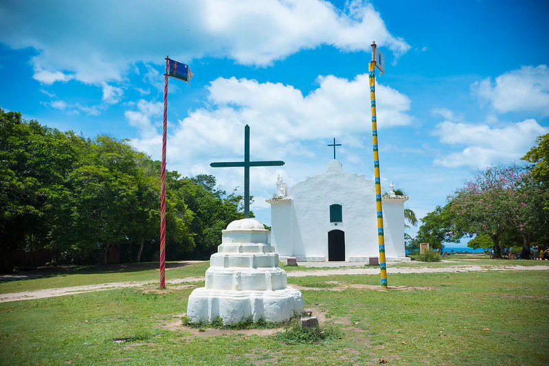 Quadrado em Trancoso próxima a Porto Seguro - Igreja pintada de branco atrás com uma cruz a frente.